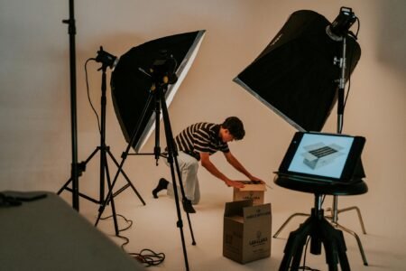 A man is setting up a photo studio in a room