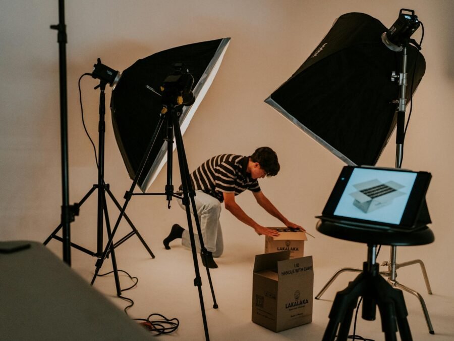 A man is setting up a photo studio in a room