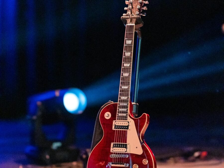 Modern electric guitar on stage against spotlight