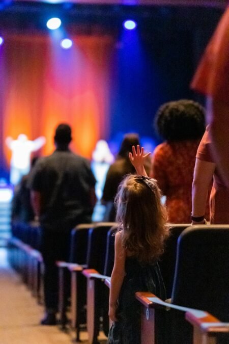 Unrecognizable spectators in concert hall during performance