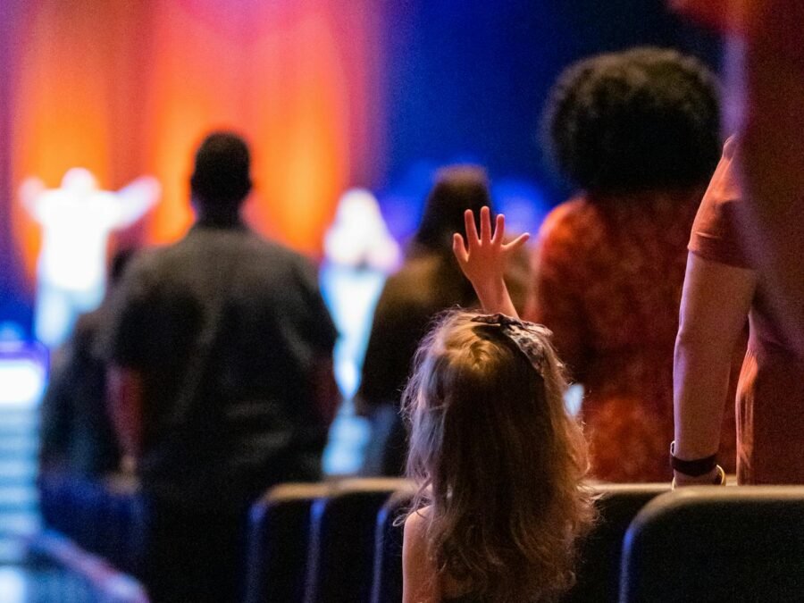 Unrecognizable spectators in concert hall during performance